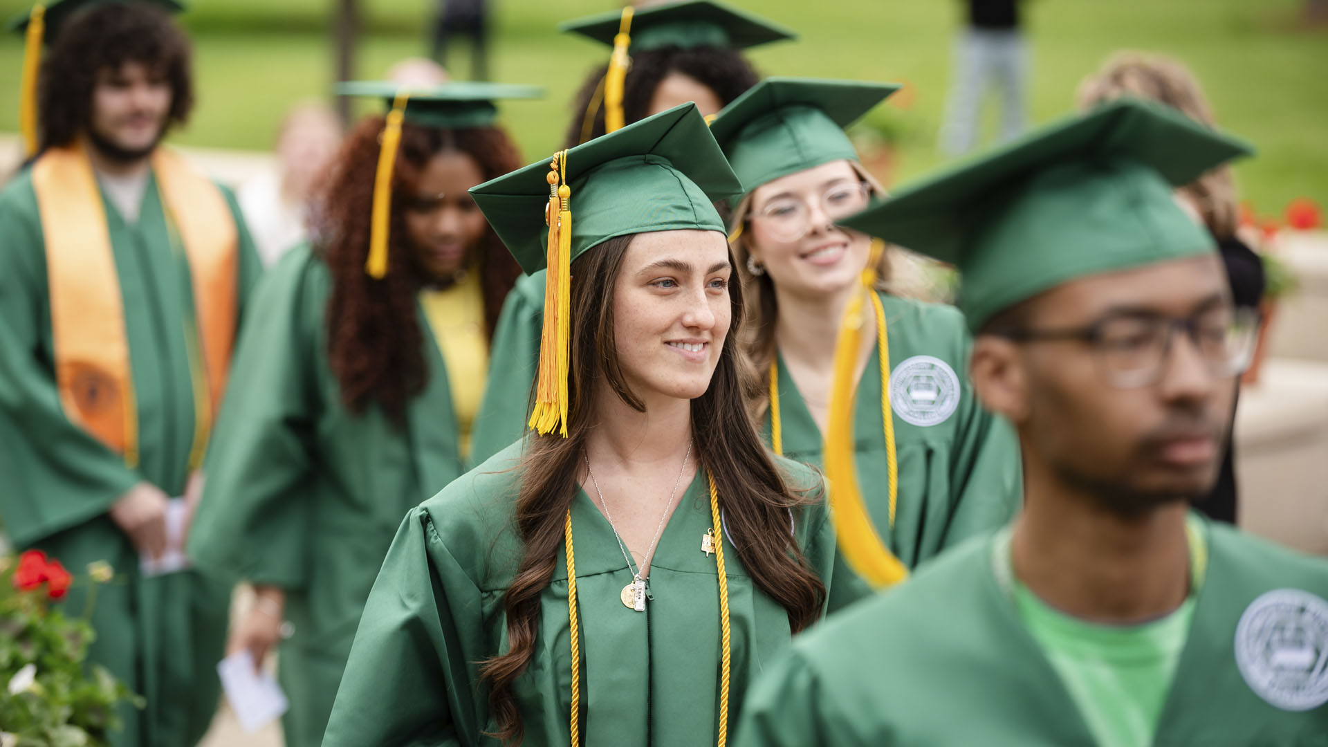 student walking to their seat in gowns