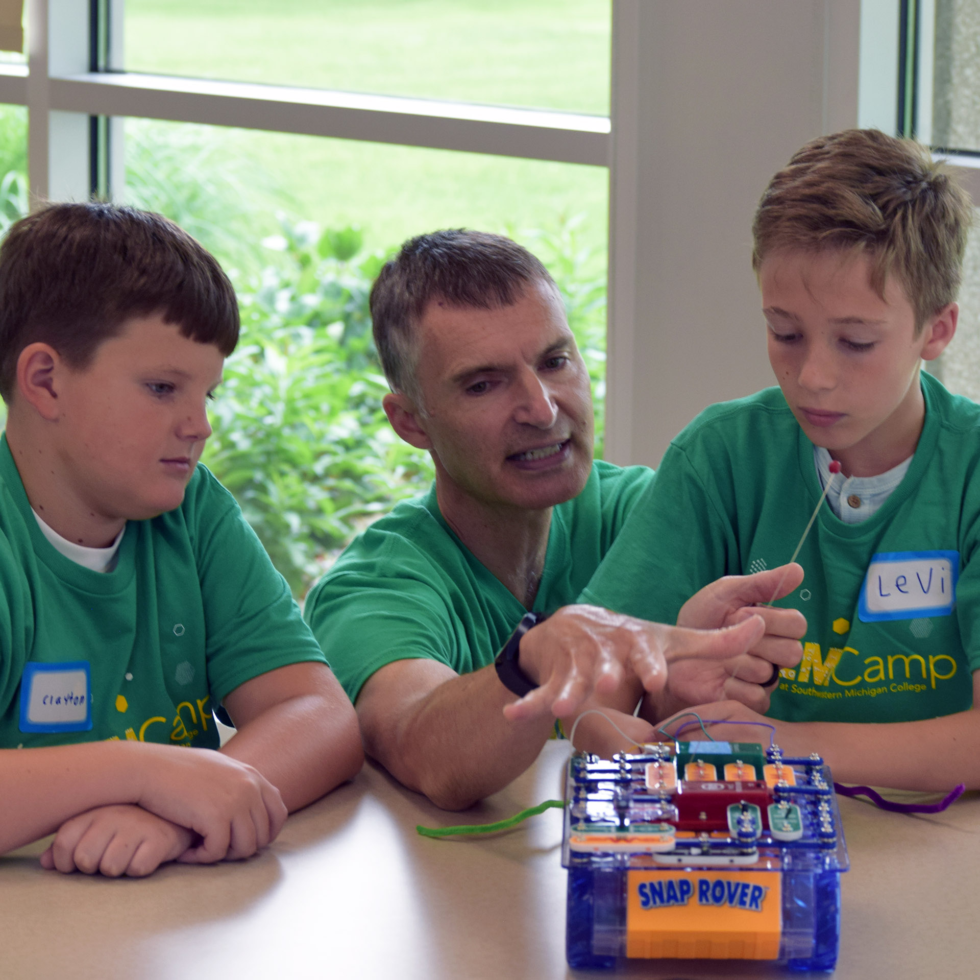 Professor Andrew Dohm coaches Levi on the Snap Rover
