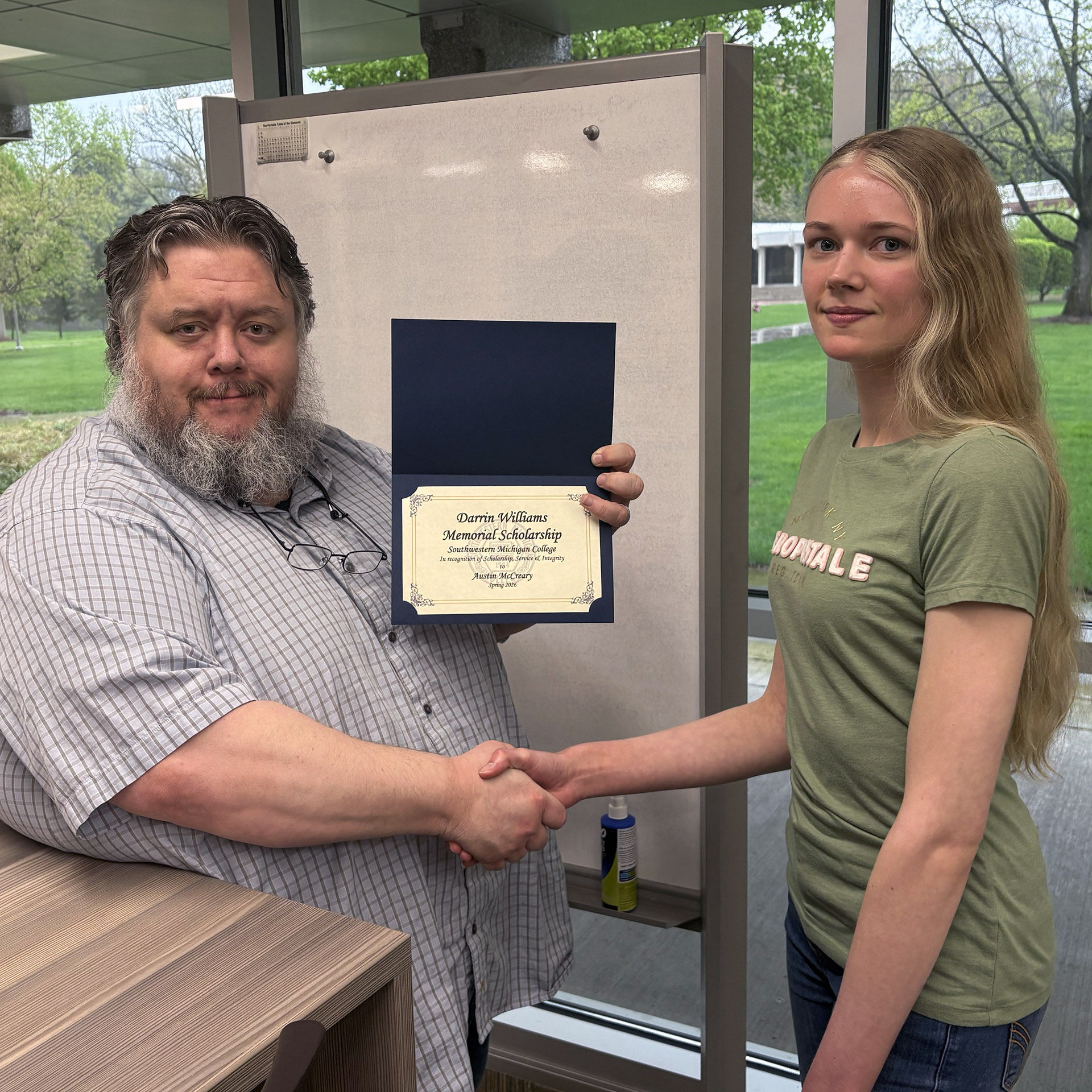 Professor of Chemistry Dr. Douglas Schauer congratulates Austin McCreary