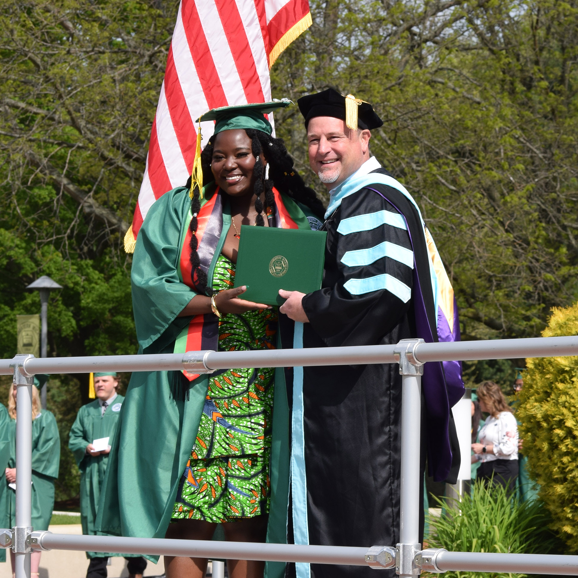 Student speaker Chloe Itimu received her diploma from President Dr. Klint Pleasant