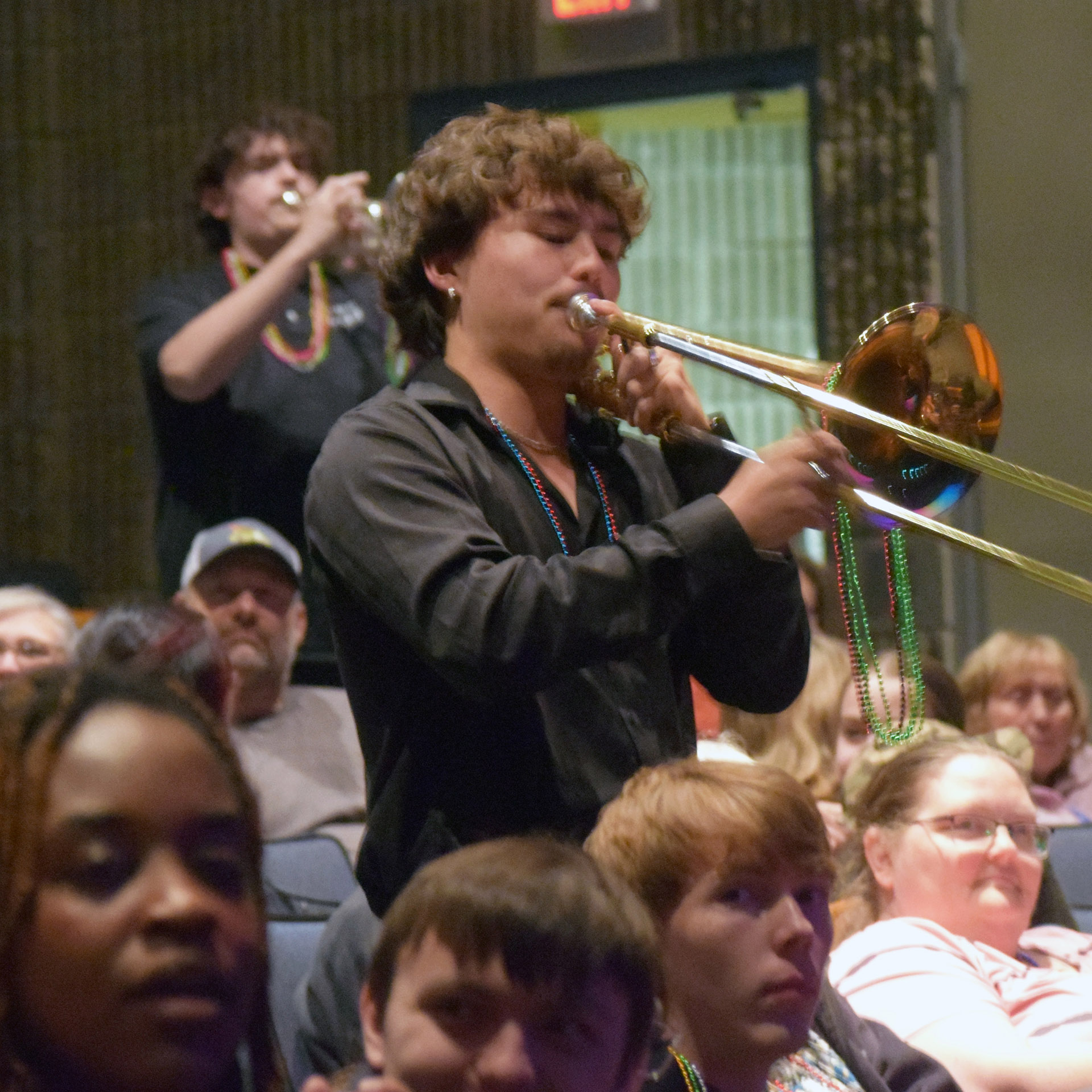 Musicians marched in draped with beads